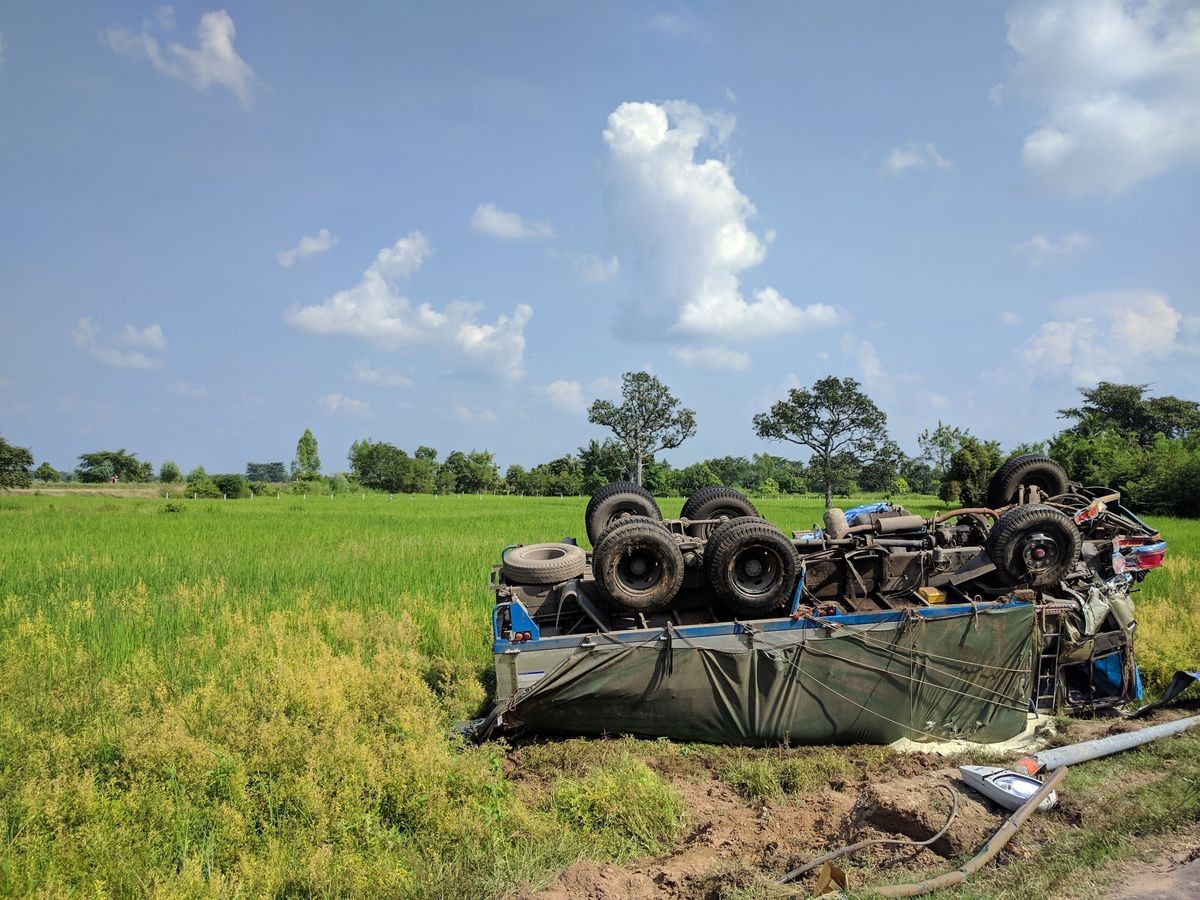 inverted big truck on rice field 